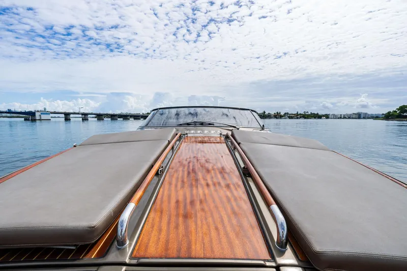 La Sirena Yacht Photos Pics 2014 Riva Rivarama luxury yacht on calm water under a partly cloudy sky.