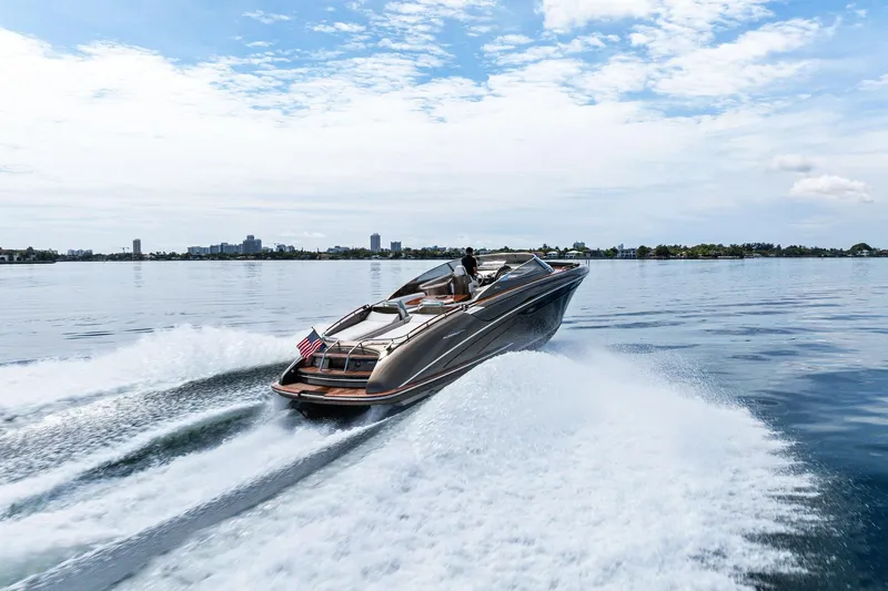 La Sirena Yacht Photos Pics 2014 Riva Rivarama luxury yacht cruising on open water, leaving a wake behind.