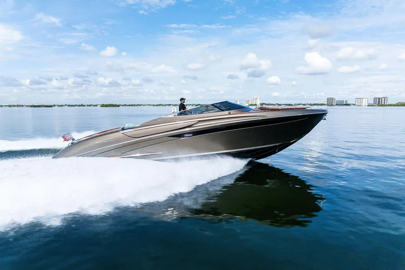La Sirena Yacht Photos Pics 2014 Riva Rivarama luxury yacht cruising on calm waters under a blue sky.