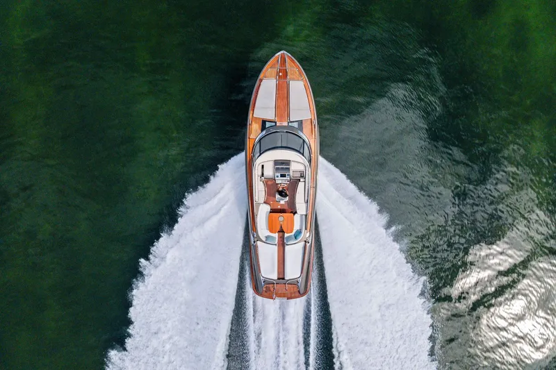La Sirena Yacht Photos Pics Aerial view of 2014 Riva Rivarama luxury yacht cruising on green water.