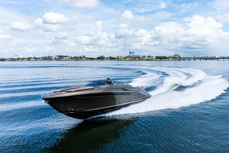 La Sirena Yacht Photos Pics 2014 Riva Rivarama luxury yacht cruising on open water under a cloudy sky.