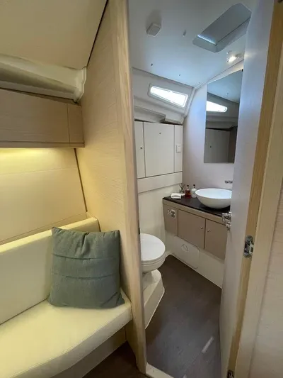Genesis Yacht Photos Pics Interior of 2021 Jeanneau 54 yacht, featuring a modern bathroom and cozy seating area.