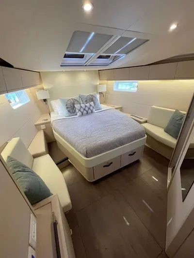 Genesis Yacht Photos Pics Luxurious interior of 2021 Jeanneau 54 yacht with cozy bed and seating area.