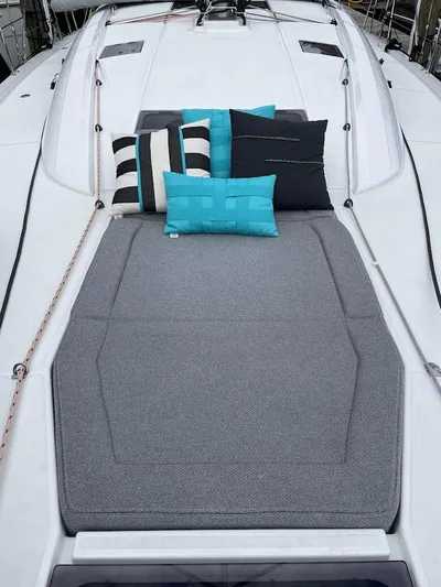 Genesis Yacht Photos Pics 2021 Jeanneau 54 yacht deck with cushions and pillows, featuring modern design and comfort.