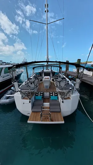 Genesis Yacht Photos Pics 2021 Jeanneau 54 yacht docked at marina, showcasing elegant design and spacious deck.