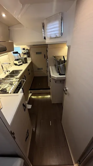 Genesis Yacht Photos Pics Interior of 2021 Jeanneau 54 yacht kitchen with modern appliances and sleek design.