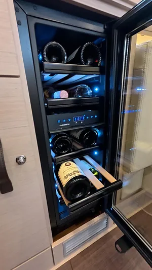Genesis Yacht Photos Pics Wine cooler in a 2021 Jeanneau 54 yacht, featuring multiple bottles and adjustable temperature settings.