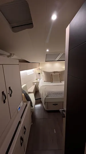 Genesis Yacht Photos Pics Luxurious interior cabin of 2021 Jeanneau 54 yacht, featuring elegant bedding and modern lighting.