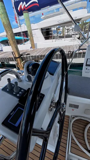 Genesis Yacht Photos Pics Steering wheel and controls of a 2021 Jeanneau 54 yacht at a marina.