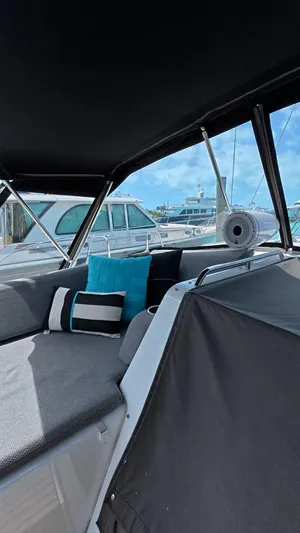 Genesis Yacht Photos Pics Interior view of a 2021 Jeanneau 54 yacht with comfortable seating and cushions.