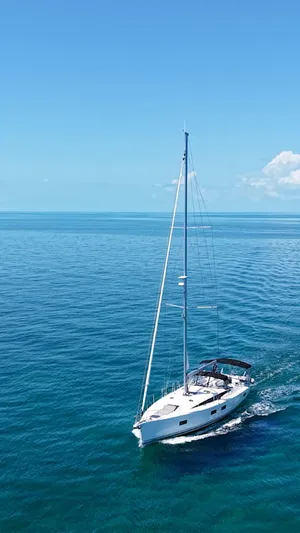 Genesis Yacht Photos Pics Sailing yacht Jeanneau 54, 2021 model, cruising on clear blue ocean waters.