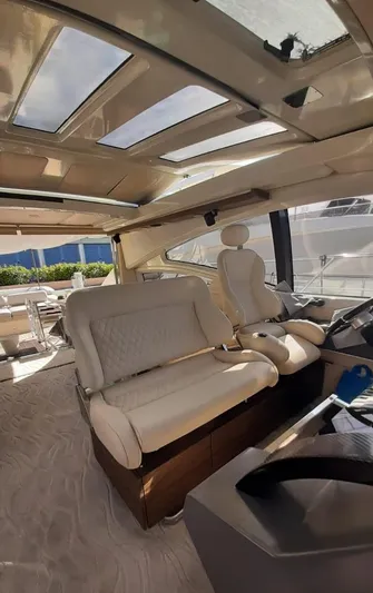  Yacht Photos Pics Luxurious interior of a 2004 Azimut 68S yacht with plush seating and panoramic windows.