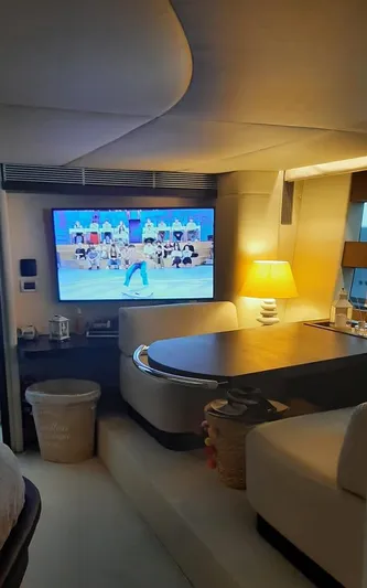  Yacht Photos Pics Luxurious interior of a 2004 Azimut 68S yacht with a cozy seating area and TV.