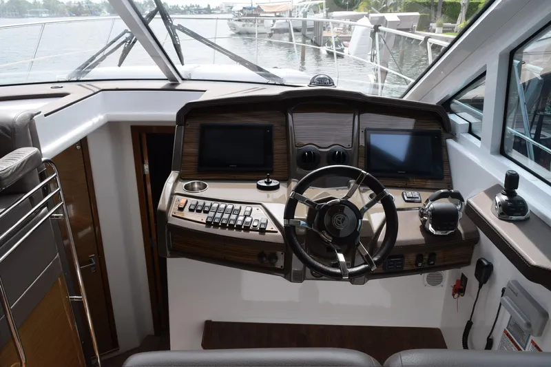 Insieme Yacht Photos Pics 2018 Cruisers Yachts 45 Cantius helm with dual screens and modern controls.