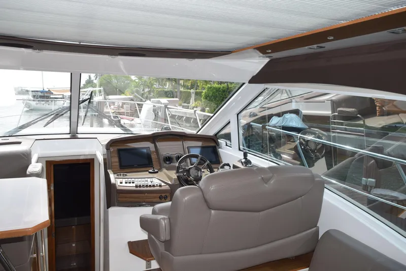 Insieme Yacht Photos Pics Interior view of 2018 Cruisers Yachts 45 Cantius helm with modern controls and seating.