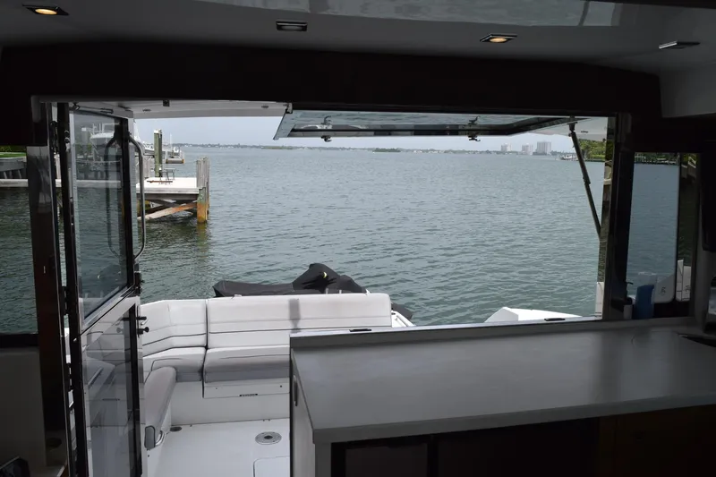 Insieme Yacht Photos Pics 2018 Cruisers Yachts 45 Cantius interior view with open deck and waterfront scenery.