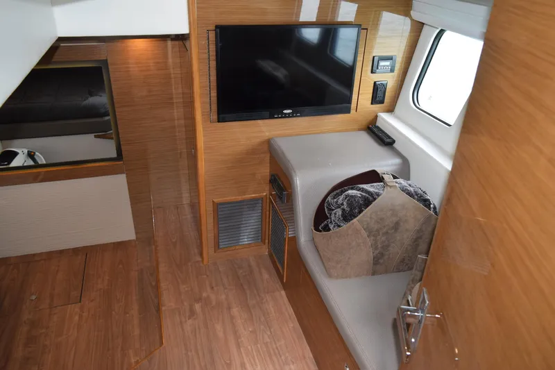 Insieme Yacht Photos Pics 2018 Cruisers Yachts 45 Cantius interior with TV, seating, and wooden flooring.