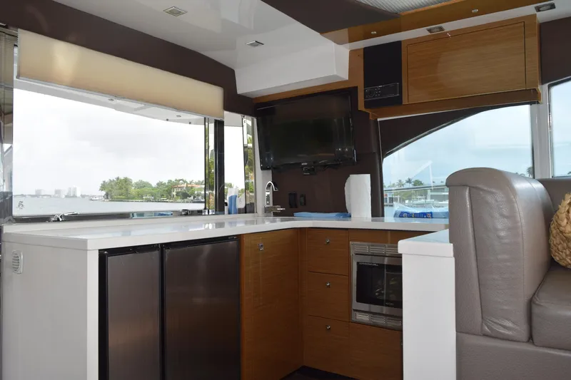 Insieme Yacht Photos Pics Interior of 2018 Cruisers Yachts 45 Cantius with modern kitchen and scenic window view.