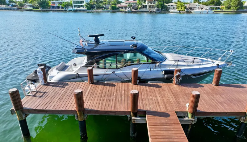 Insieme Yacht Photos Pics 2018 Cruisers Yachts 45 Cantius docked on a serene waterfront.