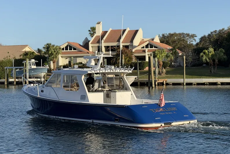 Ticklish Yacht Photos Pics True North 38 Heritage yacht from 2002 on water near coastal homes.