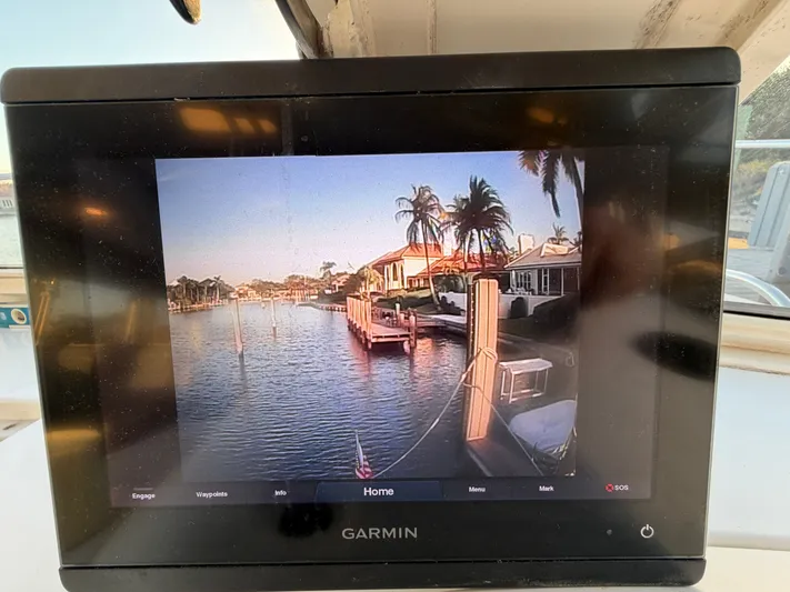 Ticklish Yacht Photos Pics Garmin display on True North 38 Heritage yacht, showing waterway with palm trees.