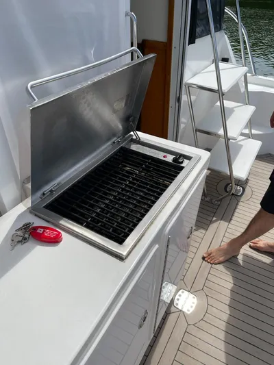 Necessity Yacht Photos Pics Outdoor grill on 2005 Albin 44 Command Bridge yacht deck, near stairs and water.