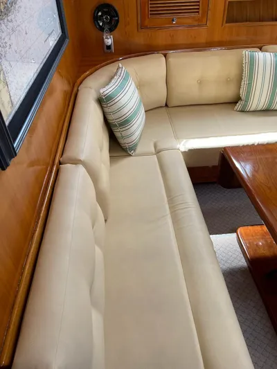 Necessity Yacht Photos Pics 2005 Albin 44 Command Bridge interior with beige seating and striped cushions.