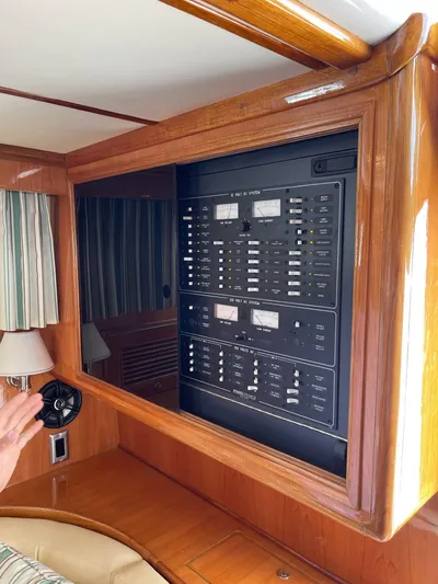 Necessity Yacht Photos Pics Control panel inside 2005 Albin 44 Command Bridge, featuring wood trim and modern switches.