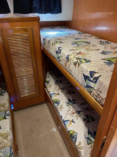 Necessity Yacht Photos Pics Bunk beds in 2005 Albin 44 Command Bridge with fish-patterned bedding.