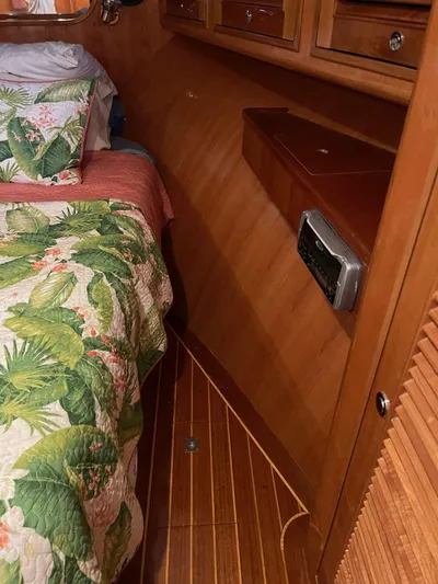 Necessity Yacht Photos Pics Interior of a 2005 Albin 44 Command Bridge with floral bedding and wooden cabinetry.