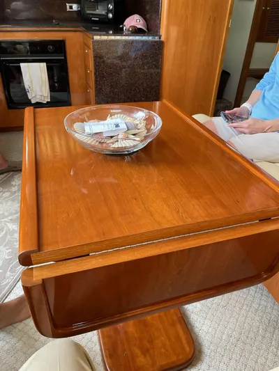 Necessity Yacht Photos Pics Interior of 2005 Albin 44 Command Bridge with wooden table and bowl.