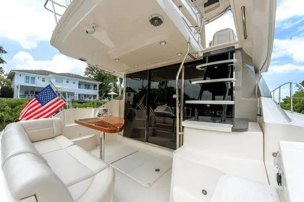No Pods - V-drive Yacht Photos Pics 2015 Sea Ray 510 Fly yacht with outdoor seating and American flag.