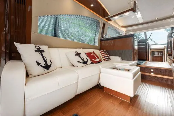 No Pods - V-drive Yacht Photos Pics Luxurious interior of 2015 Sea Ray 510 Fly yacht with white leather seating and nautical decor.