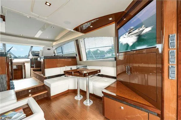No Pods - V-drive Yacht Photos Pics Luxurious interior of 2015 Sea Ray 510 Fly yacht with modern seating and wood finishes.