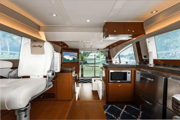 No Pods - V-drive Yacht Photos Pics Luxurious interior of 2015 Sea Ray 510 Fly yacht with modern kitchen and seating area.