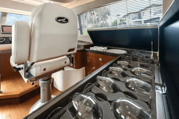 No Pods - V-drive Yacht Photos Pics Luxurious interior of 2015 Sea Ray 510 Fly yacht with elegant seating and glassware storage.