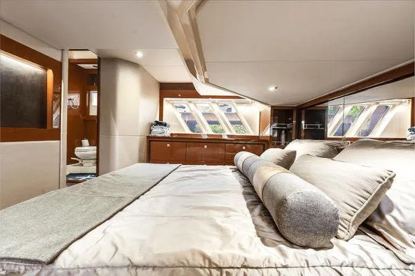 No Pods - V-drive Yacht Photos Pics Luxurious bedroom interior of 2015 Sea Ray 510 Fly yacht with elegant bedding and natural light.