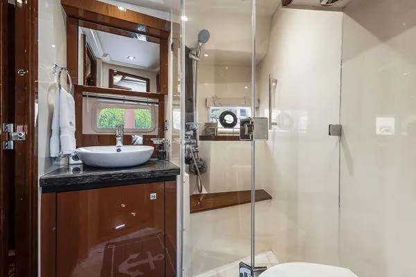 No Pods - V-drive Yacht Photos Pics Luxurious bathroom in 2015 Sea Ray 510 Fly yacht with modern fixtures and glass shower.