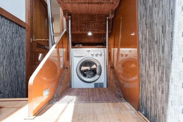 No Pods - V-drive Yacht Photos Pics Laundry area inside a 2015 Sea Ray 510 Fly yacht, featuring a washing machine.