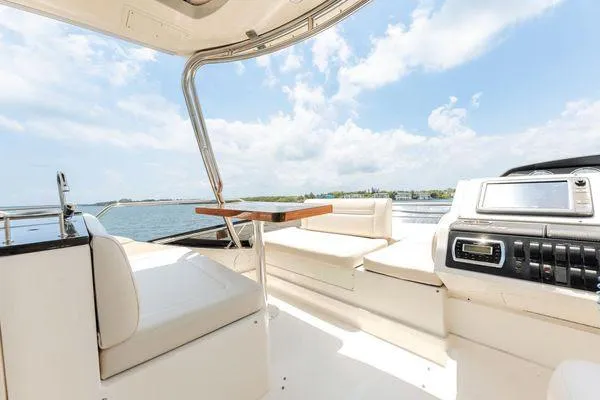 No Pods - V-drive Yacht Photos Pics Luxurious 2015 Sea Ray 510 Fly yacht interior with plush seating and scenic ocean view.