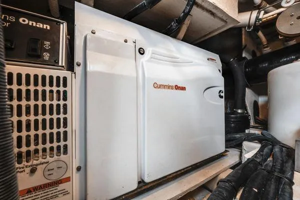 No Pods - V-drive Yacht Photos Pics Cummins Onan generator in 2015 Sea Ray 510 Fly engine room, showcasing marine power equipment.