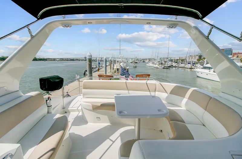 No Surrender Yacht Photos Pics 2000 Carver 530 Voyager Pilothouse yacht with spacious seating and scenic marina view.