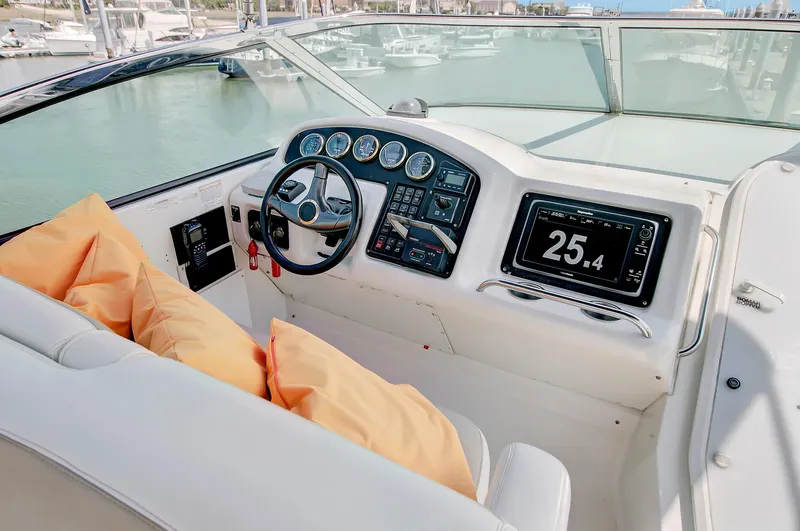 No Surrender Yacht Photos Pics Pilothouse of 2000 Carver 530 Voyager with modern dashboard and orange cushions.