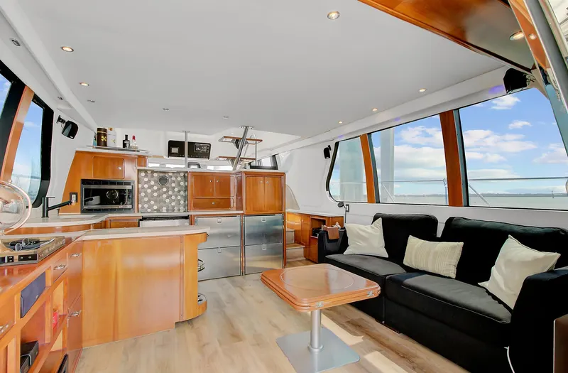 No Surrender Yacht Photos Pics Luxurious interior of 2000 Carver 530 Voyager Pilothouse yacht with modern kitchen and seating area.