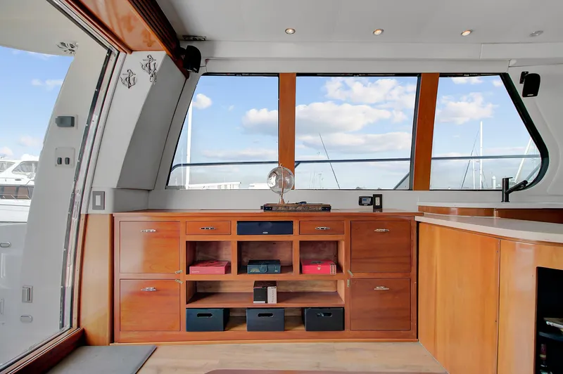 No Surrender Yacht Photos Pics Interior of 2000 Carver 530 Voyager Pilothouse with wooden cabinetry and large windows.