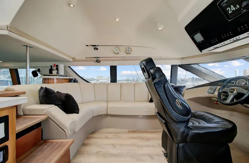 No Surrender Yacht Photos Pics Luxurious interior of 2000 Carver 530 Voyager Pilothouse with plush seating and modern helm.