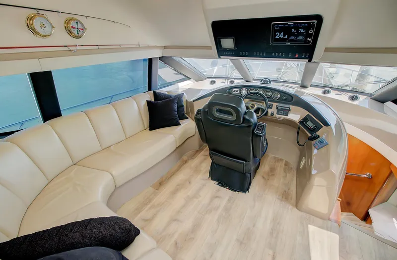 No Surrender Yacht Photos Pics Pilothouse interior of 2000 Carver 530 Voyager with leather seating and modern dashboard.