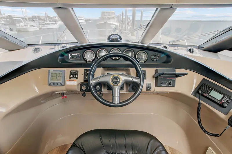 No Surrender Yacht Photos Pics Pilothouse of 2000 Carver 530 Voyager, featuring steering wheel and navigation instruments.