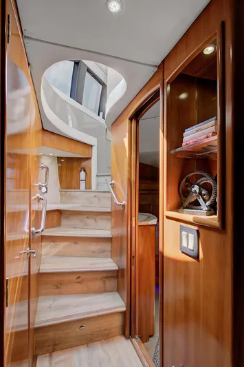 No Surrender Yacht Photos Pics Interior of 2000 Carver 530 Voyager Pilothouse with wooden stairs and elegant design.