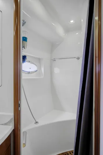 No Surrender Yacht Photos Pics Shower area in 2000 Carver 530 Voyager Pilothouse yacht, featuring sleek white design and modern fixtures.